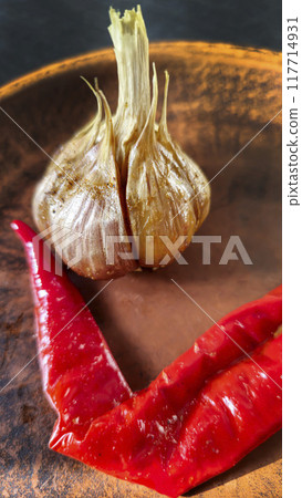 Garlic on dark background for cooking home food. Useful antibacterial product. Garlic on dark background for cooking home food. Useful antibacterial product. 117714931
