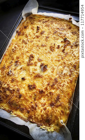 Moussaka made at home. Golden cheese crust. Food in a pan on the stove. Moussaka made at home. Golden cheese crust. Food in a pan on the stove. 117714954