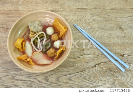 boiled fish and shrimp ball couple dumpling topping pickled cuttlefish in red soybean sauce soup topping fried crispy yellow dumpling flour on bowl 117715456