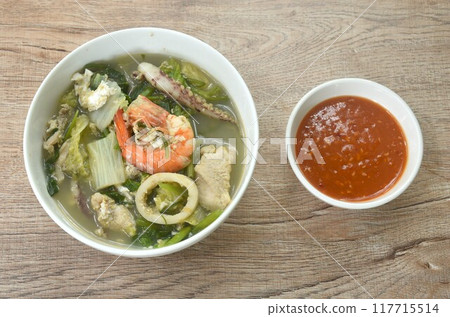 boiled sukiyaki seafood chicken and pork meat couple crispy pickled squid and shrimp with vegetable in soup on bowl dipping sauce 117715514