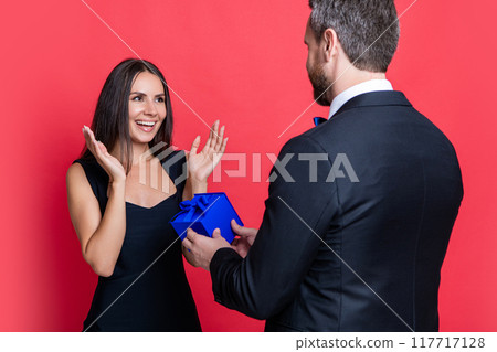 glad love couple with present at studio. love couple with present on background. 117717128