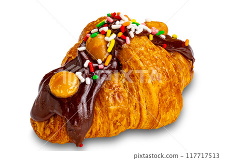 Croissant garnished with chocolate and rainbow sprinkles. 117717513