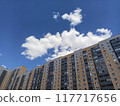 High rise building with blue sky and white clouds, closeup of photo	 117717656