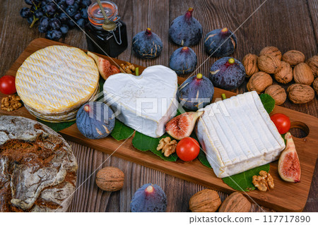 Selection of French cheeses from Normandy, AOP, Livarot, Neufchatel, Pont l'eveque, Rye bread, figs 117717890