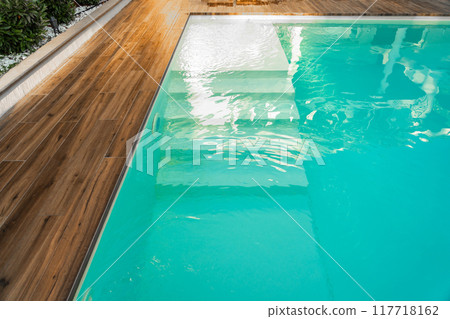 Swimming pool entrance steps with clean blue water at modern villa 117718162