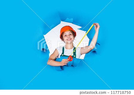 self-retracting metal tape measure. Little girl using a measuring tape. construction worker with tape measure. Cute kid as a construction worker. kid repairing home. happy childhood. Can you help me 117718750