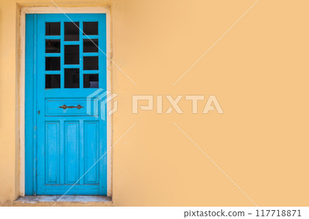 Yellow wall background with blue retro door 117718871