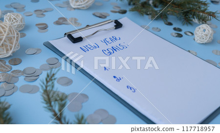 Handwritten new year resolutions aims goals on paper notepad. Preparation for New Year. Planning and setting goals for personal development Handwritten new year resolutions aims goals on paper notepad. Preparation for New Year. Planning and setting goals for personal development 117718957