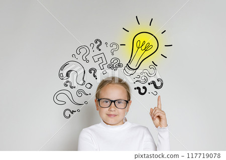 Clever child girl with light bulb and question marks on white background.  117719078
