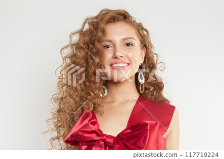 Beautiful young adult woman with fresh skin and wavy long healthy hairstyle isolated Beautiful young adult woman with fresh skin and wavy long healthy hairstyle isolated 117719224
