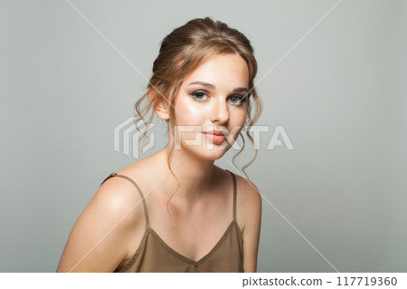 Perfect adorable woman wearing green blouse. Model with make-up and updo hair, beautiful hairdo 117719360