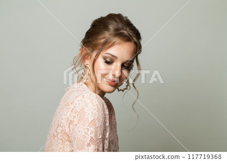 Perfect elegance woman with fresh skin, updo hair and makeup on white background. Perfect elegance woman with fresh skin, updo hair and makeup on white background. 117719368