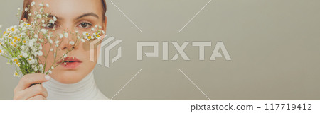 Beautiful woman face on gray banner background. Mental health and psychology concept Beautiful woman face on gray banner background. Mental health and psychology concept 117719412