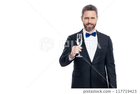 man in tuxedo to cheers and celebrate, copy space. tuxedo man hold champagne. 117719423