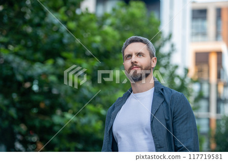 caucasian guy looking up outside. photo of caucasian guy in white shirt. caucasian guy outdoor. caucasian guy looking up outside. photo of caucasian guy in white shirt. caucasian guy outdoor. 117719581