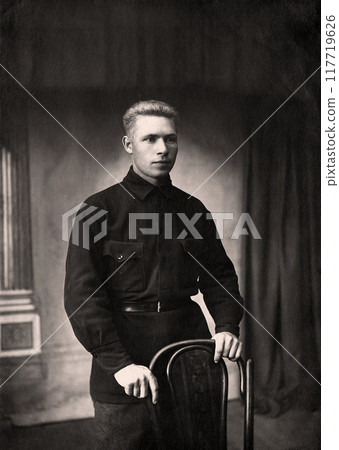 Vintage photo of a young man in typical clothing in the USSR in the 1930s. Photo from 1937 Vintage photo of a young man in typical clothing in the USSR in the 1930s. Photo from 1937 117719626