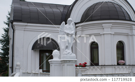 Bagrationovsk - August 23, 2024. The Temple of Faith, Hope, Love and their mother Sophia in Bagrationovsk, Russia. Angel statue in front of the church. Bagrationovsk - August 23, 2024. The Temple of Faith, Hope, Love and their mother Sophia in Bagrationovsk, Russia. Angel statue in front of the church. 117719928