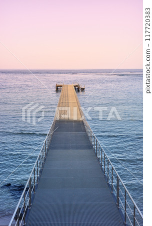 Empty pier at purple sunset. 117720383