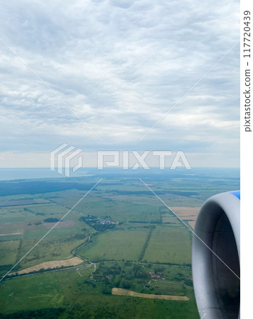 airplane turbine and view of green fields airplane turbine and view of green fields 117720439