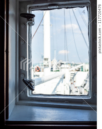 closed window in cabin of white ship 117720476