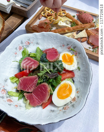 tuna and egg on green salad in local cafe 117720618