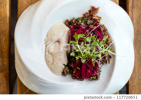 meat and vegetable salad in plate on wooden table meat and vegetable salad in plate on wooden table 117720651