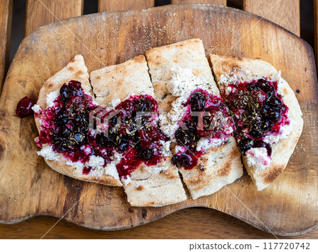 focaccia with herbed cheese and jam on wood table focaccia with herbed cheese and jam on wood table 117720742