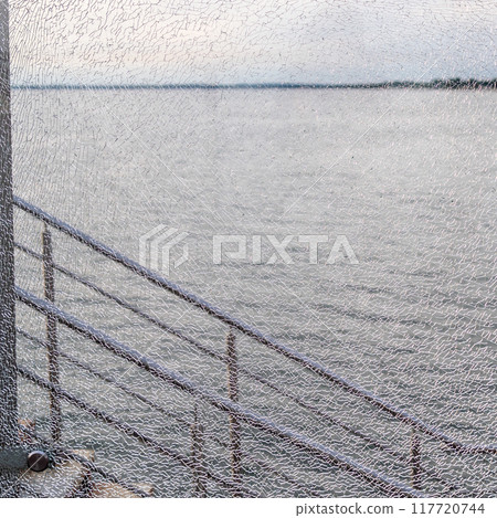 gray water of Baltic Sea through cracked glass gray water of Baltic Sea through cracked glass 117720744