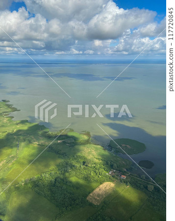 above view of clouds and green coast of Baltic Sea 117720845