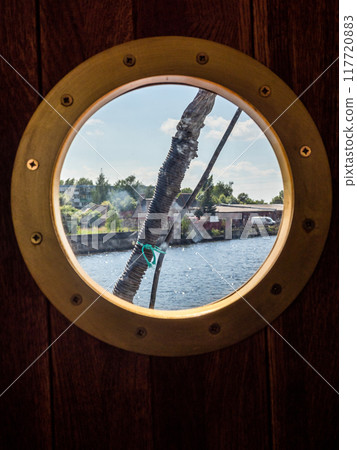 yellow porthole in wooden cabin yellow porthole in wooden cabin 117720883
