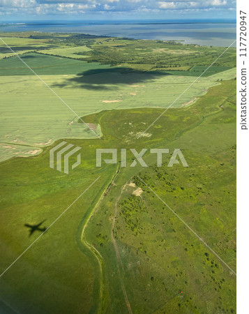 green coast of Baltic Sea and airplane shadow green coast of Baltic Sea and airplane shadow 117720947