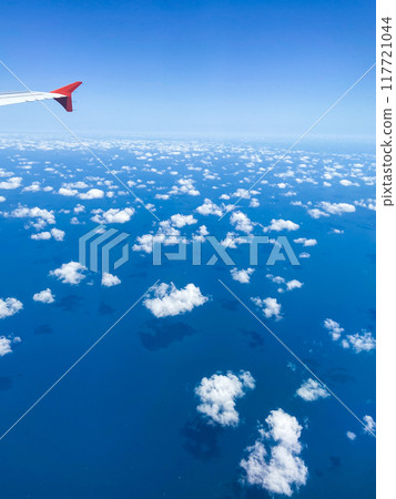 aerial view of white fluffy clouds over blue sea 117721044