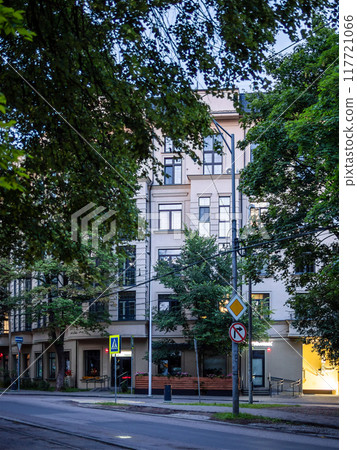 apartment building on street at summer dusk 117721066