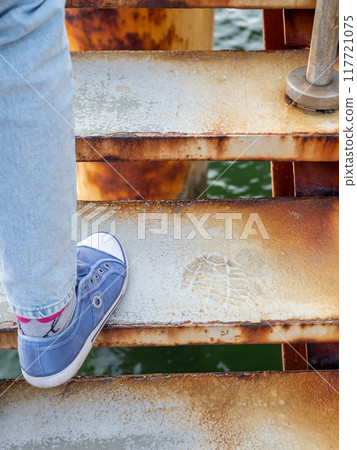foot steps up steps of metal pier staircase 117721075