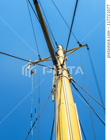 yellow mast of ship and blue sky yellow mast of ship and blue sky 117721077