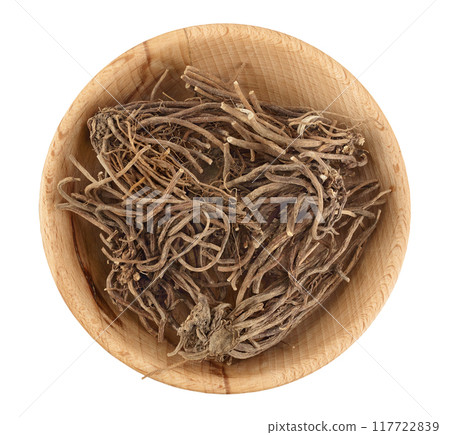 Dried Valerian root in wooden bowl isolated on white background. Valeriana officinalis with full depth of field. Top view. Flat lay 117722839