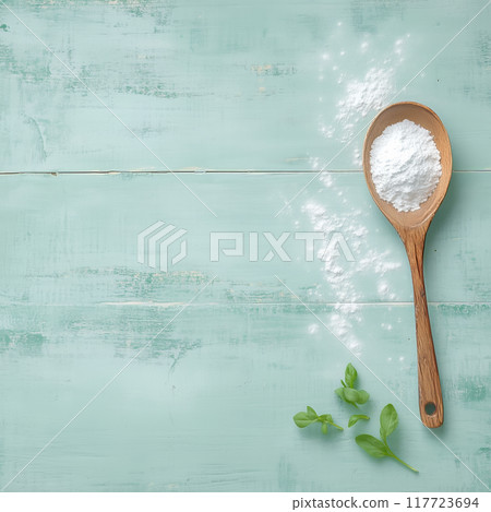 Spoon filled with flour on turquoise wooden surface 117723694