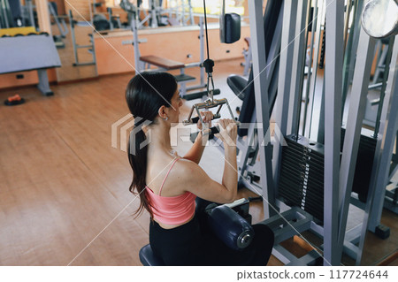 Woman Hands Grabbing The Handle Of The Gym Machine Woman Hands Grabbing The Handle Of The Gym Machine 117724644