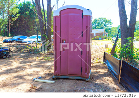 Portable plastic bio toilet cabins located on construction site during construction of house 117725019