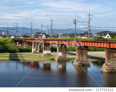 Yamato River and Kintetsu Myoji Line railway bridge in midsummer 117725222
