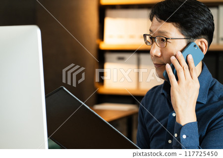 中年男子用電腦打電話 117725450