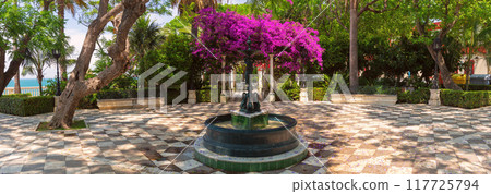 City garden with a fountain on the Cadiz waterfront. 117725794