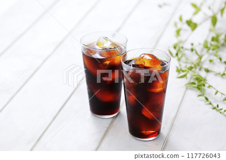 iced coffee poured into a glass iced coffee poured into a glass 117726043