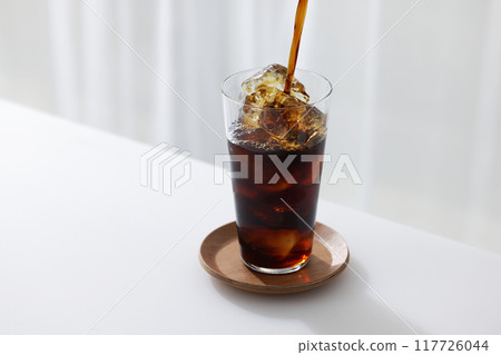 iced coffee poured into a glass 117726044