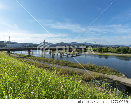A view of the Kintetsu Railway Myoji Line's iron bridge over the Yamato River and the mountains A view of the Kintetsu Railway Myoji Line's iron bridge over the Yamato River and the mountains 117726089