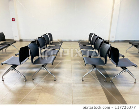 rows of airport chairs in a modern terminal, clean, sleek design of seating arrangements often seen in airports, providing a calm and organized environment, travel, transportation, airport design 117726377