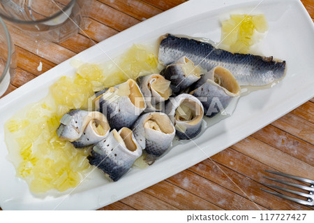 Herring fillet with onion and sunflower oil Herring fillet with onion and sunflower oil 117727427