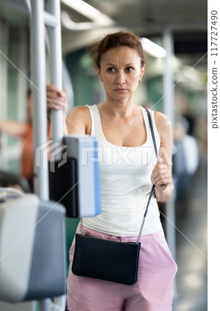 Portrait of an attractive middle-aged woman on bus or tram Portrait of an attractive middle-aged woman on bus or tram 117727490