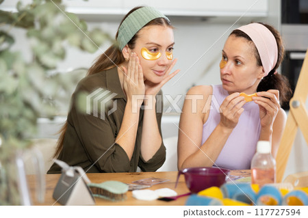 Adult and young women use eye patches 117727594