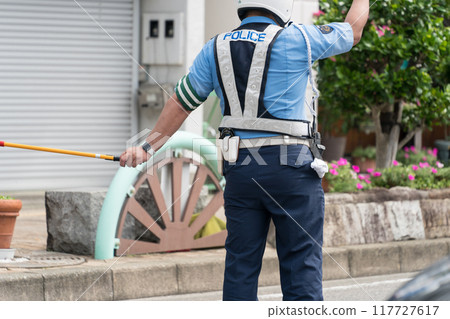 Police officer directing traffic Police officer directing traffic 117727617